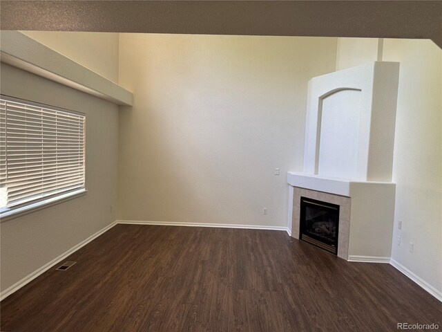 13959 Eudora St, Thornton, CO 80602 - unfurnished living room featuring wood finished floors, baseboards, and a tiled fireplace