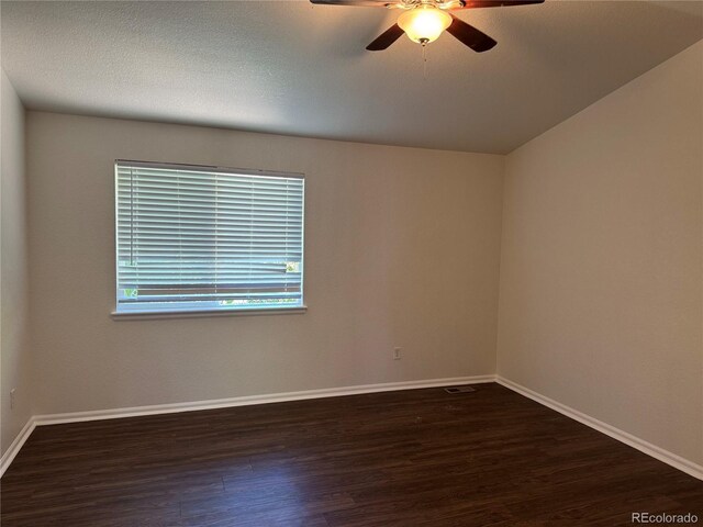 13959 Eudora St, Thornton, CO 80602 - empty room featuring dark wood-type flooring, ceiling fan, and baseboards