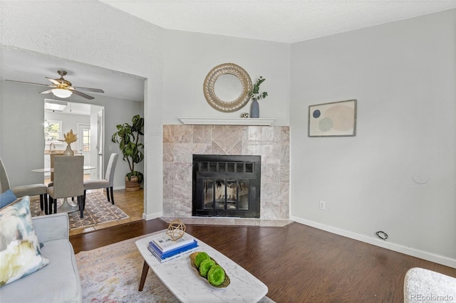 8260 Washington St Unit 78, Denver, CO 80229 - living area with wood finished floors, ceiling fan, a fireplace, and a textured ceiling