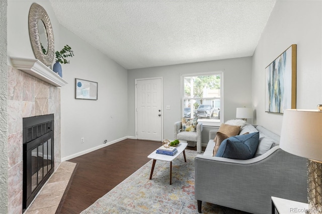 8260 Washington St Unit 78, Denver, CO 80229 - living room with wood finished floors, a textured ceiling, and a tiled fireplace
