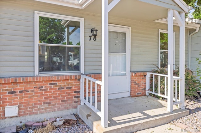 8260 Washington St Unit 78, Denver, CO 80229 - view of exterior entry featuring brick siding and a porch