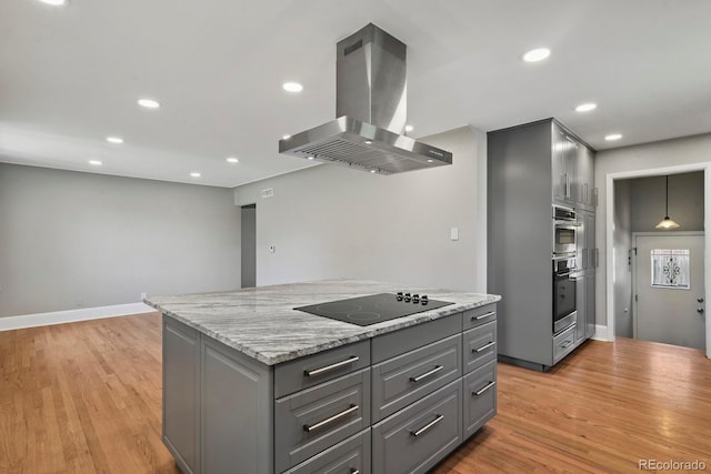 10595 E 23rd Ave, Aurora, CO 80010 - kitchen with gray cabinetry, island exhaust hood, black electric cooktop, light wood-style floors, and a kitchen island