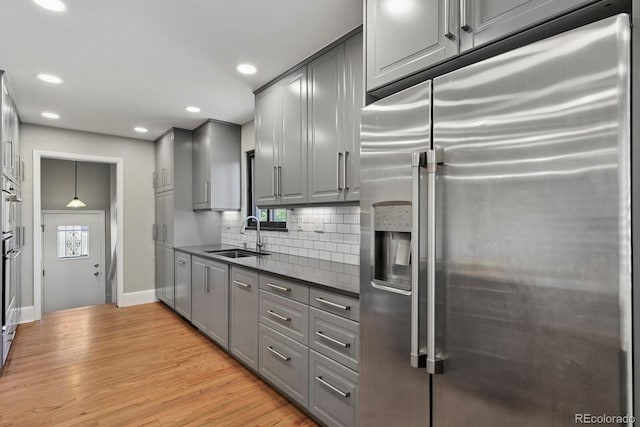 10595 E 23rd Ave, Aurora, CO 80010 - kitchen featuring stainless steel fridge with ice dispenser, gray cabinetry, dark countertops, decorative backsplash, and recessed lighting