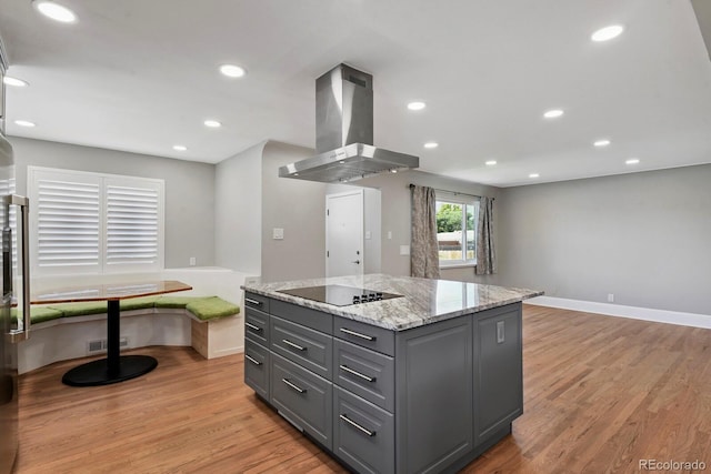 10595 E 23rd Ave, Aurora, CO 80010 - kitchen with wall chimney range hood, black electric cooktop, gray cabinetry, light wood-type flooring, and recessed lighting