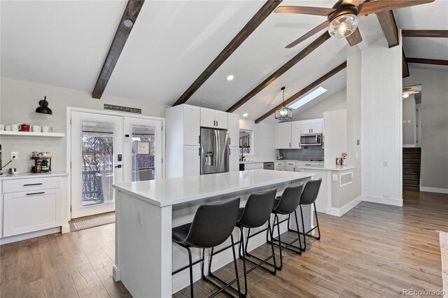 9630 N Surrey Dr, Castle Rock, CO 80108 - kitchen with appliances with stainless steel finishes, ceiling fan, white cabinets, light countertops, and recessed lighting