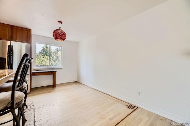 4934 S Flower Way, Littleton, CO 80123 - dining space with light wood-style flooring and baseboards