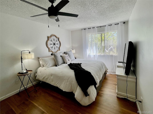 4934 S Flower Way, Littleton, CO 80123 - bedroom with a textured ceiling, wood finished floors, baseboards, and a ceiling fan