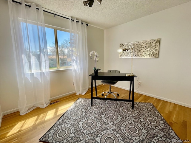 4934 S Flower Way, Littleton, CO 80123 - office space with wood finished floors, a textured ceiling, and baseboards