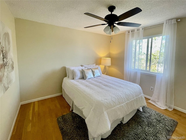 4934 S Flower Way, Littleton, CO 80123 - bedroom with a textured ceiling, wood finished floors, baseboards, and ceiling fan