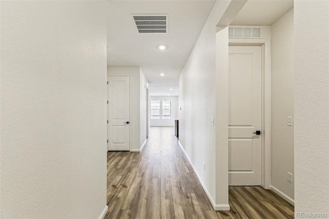 hallway with hardwood / wood-style floors