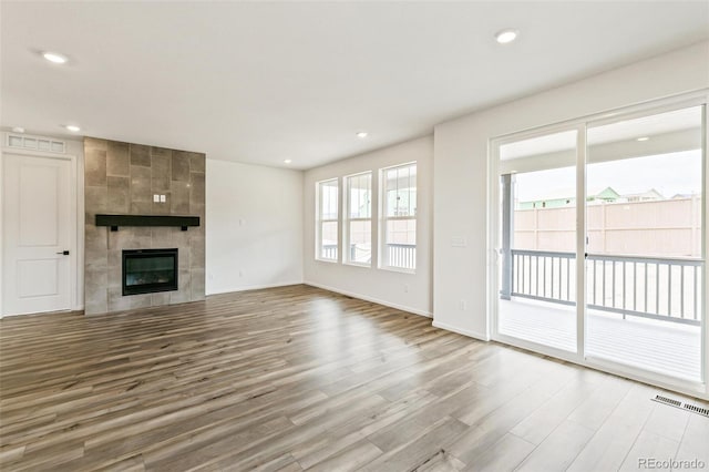 unfurnished living room with light wood-type flooring and a fireplace