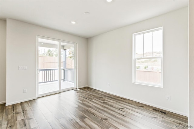 unfurnished room with light hardwood / wood-style flooring