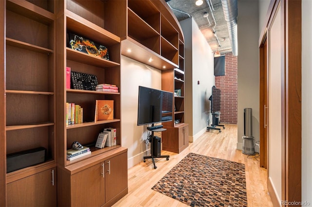 office area with light wood-style flooring and baseboards