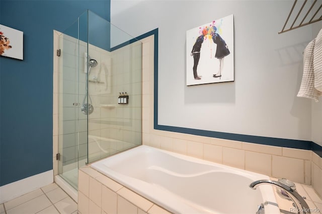 full bathroom with a stall shower, baseboards, a bath, and tile patterned floors