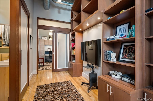 office area featuring light wood finished floors and baseboards