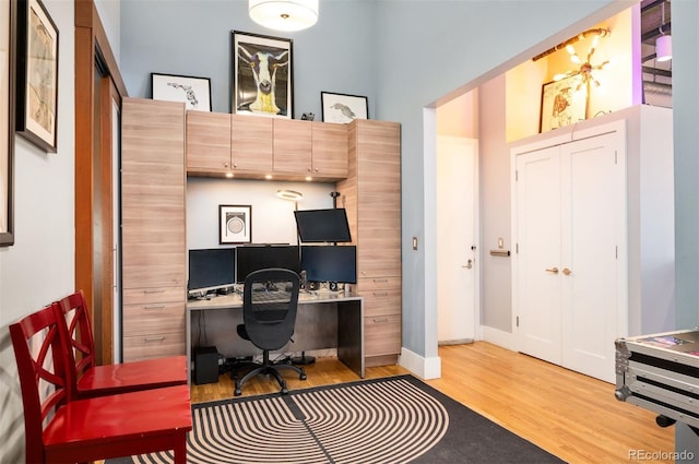 office area featuring baseboards and light wood-style floors