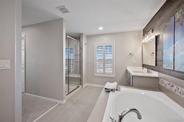 bathroom with vanity, a garden tub, visible vents, and a shower stall