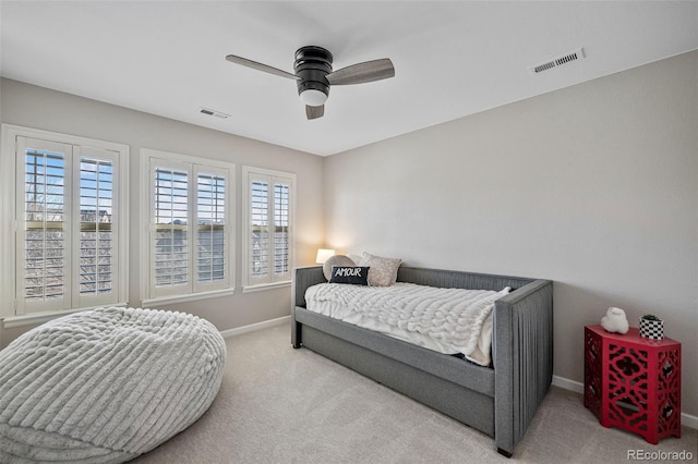 bedroom featuring visible vents, ceiling fan, light carpet, and baseboards