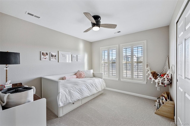 bedroom with a ceiling fan, visible vents, light carpet, and baseboards