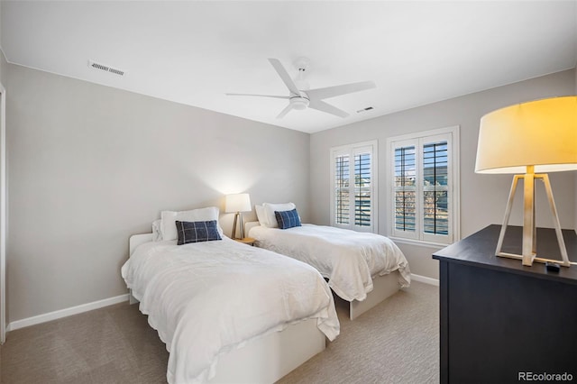 carpeted bedroom with visible vents, ceiling fan, and baseboards