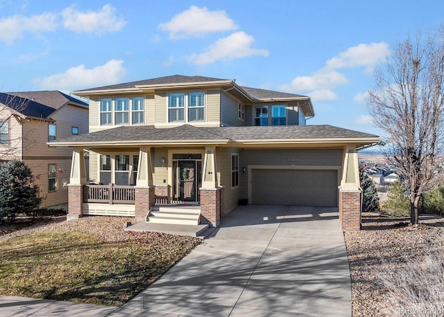 prairie-style house with a garage, concrete driveway, a porch, and brick siding