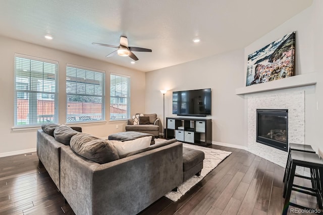 14067 Hudson St, Thornton, CO 80602 - living area with ceiling fan, dark wood-type flooring, baseboards, a glass covered fireplace, and recessed lighting