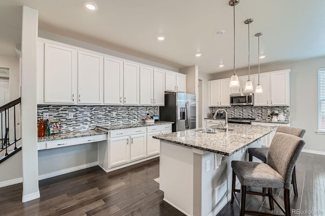 14067 Hudson St, Thornton, CO 80602 - kitchen with appliances with stainless steel finishes, a sink, dark wood-style flooring, tasteful backsplash, and white cabinets