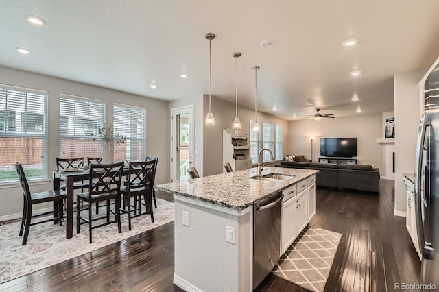14067 Hudson St, Thornton, CO 80602 - kitchen featuring a sink, dishwasher, dark wood finished floors, a ceiling fan, and open floor plan