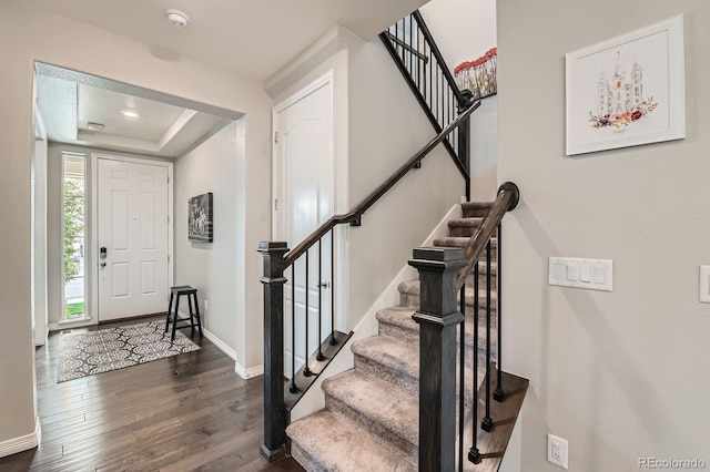 14067 Hudson St, Thornton, CO 80602 - foyer with dark wood-style floors, stairs, baseboards, and a tray ceiling