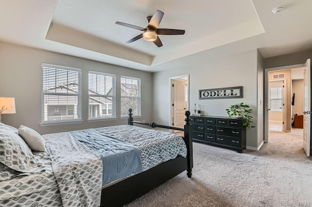 14067 Hudson St, Thornton, CO 80602 - carpeted bedroom with a tray ceiling, baseboards, and ceiling fan