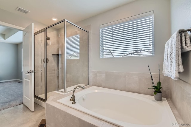 14067 Hudson St, Thornton, CO 80602 - bathroom featuring a bath, healthy amount of natural light, a stall shower, and tile patterned floors