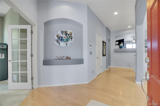 hall with baseboards, wood finished floors, and recessed lighting