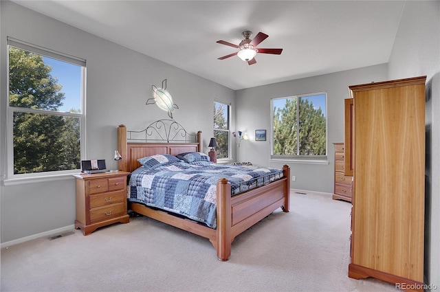 bedroom featuring light colored carpet and ceiling fan