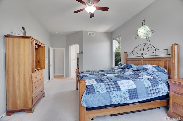 bedroom featuring arched walkways, light carpet, visible vents, baseboards, and a ceiling fan