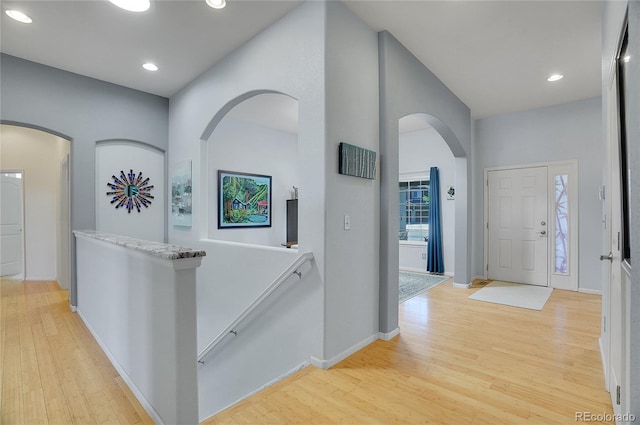 hallway with recessed lighting, baseboards, and light wood finished floors