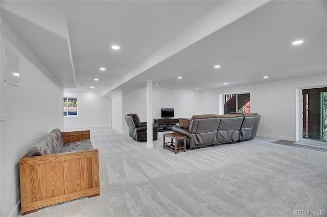 living area with recessed lighting, light colored carpet, and baseboards