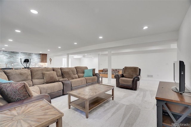 living room featuring recessed lighting, visible vents, and light colored carpet