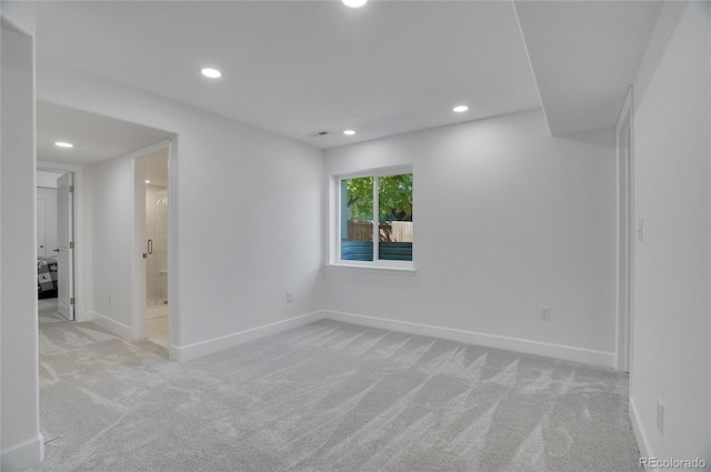 carpeted empty room featuring recessed lighting and baseboards