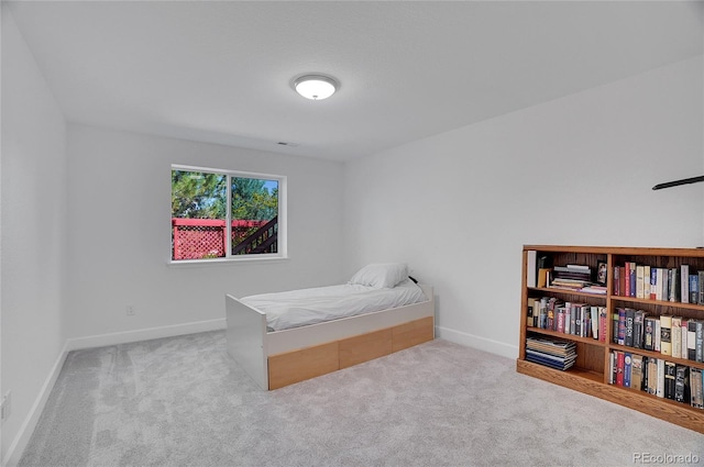 bedroom featuring carpet, visible vents, and baseboards