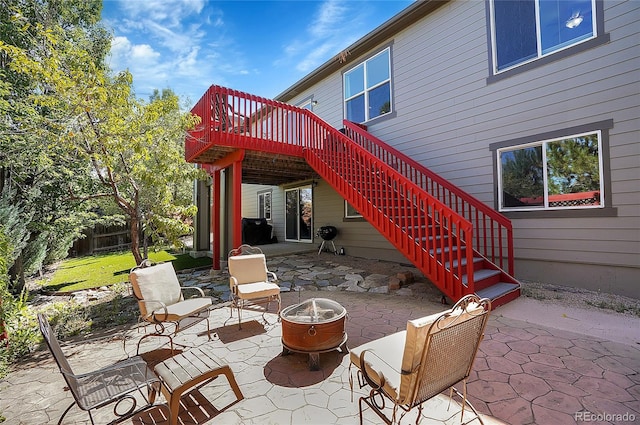 view of patio / terrace with an outdoor fire pit and a wooden deck