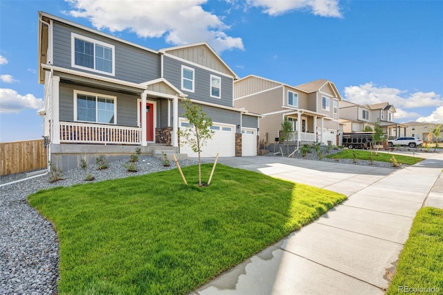 view of front of home featuring a front lawn, a porch, and a garage