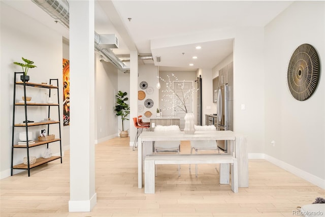 dining area featuring light wood-type flooring