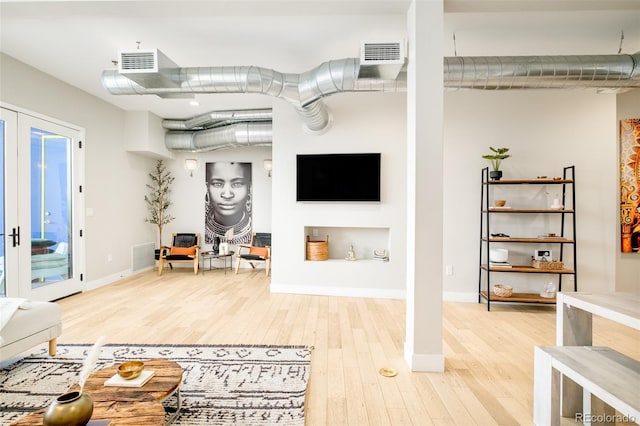 living room featuring hardwood / wood-style floors and french doors