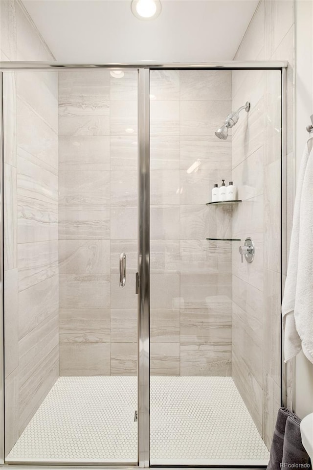 bathroom with a shower with door