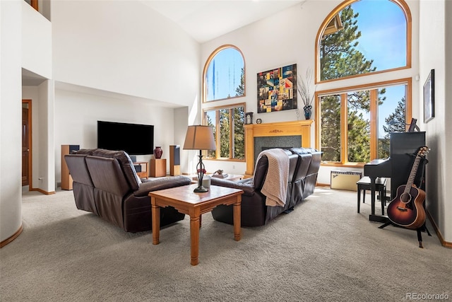 6252 King Dr, Evergreen, CO 80439 - living area with high vaulted ceiling, light carpet, baseboards, and a fireplace