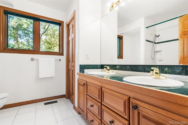 6252 King Dr, Evergreen, CO 80439 - bathroom featuring double vanity, toilet, baseboards, a shower, and tile patterned flooring