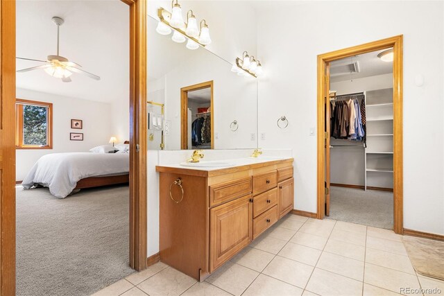 6252 King Dr, Evergreen, CO 80439 - bathroom featuring ensuite bath, double vanity, ceiling fan, tile patterned flooring, and a spacious closet