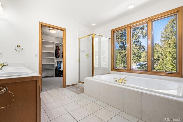 6252 King Dr, Evergreen, CO 80439 - bathroom featuring healthy amount of natural light, a shower stall, tile patterned flooring, a garden tub, and recessed lighting