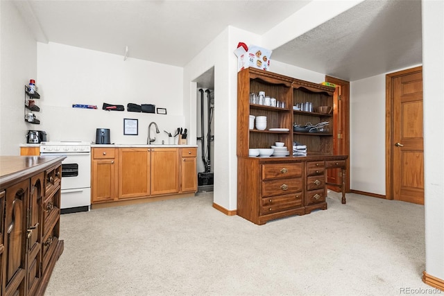 6252 King Dr, Evergreen, CO 80439 - kitchen with white range with electric stovetop, light colored carpet, a sink, and baseboards