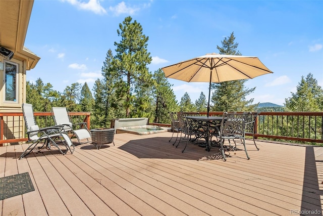 6252 King Dr, Evergreen, CO 80439 - deck with outdoor dining space, a covered hot tub, and a mountain view